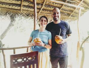 a man and a woman holding food in their hands at Atha Tree House in Habarana
