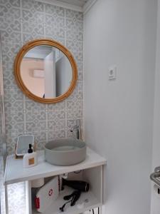 a bathroom with a sink and a mirror on the wall at Páteo da Memória Casa do Pintor in Quinta do Anjo +40 photos