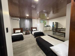 a hotel room with two beds and a kitchen at Bunker593 Inn in Tena