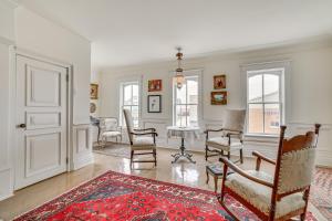 a living room with chairs and a grand piano at Walkable Main Street Location Spring Grove Apt in Spring Grove