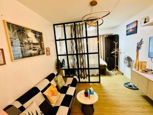 a living room with a couch and a table at Staycation 941 in Manila