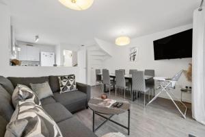 a living room with a couch and a table at Spacious 4 BR House w/Parking in Birmingham