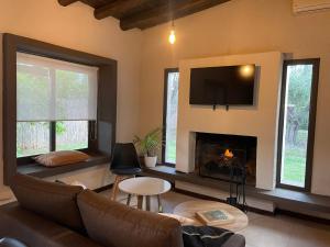 a living room with a couch and a fireplace at Comarca Andina in Ciudad Lujan de Cuyo
