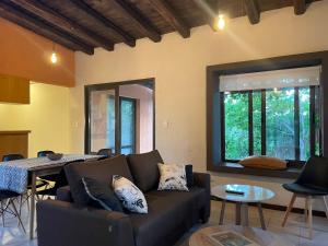 a living room with a couch and a table at Comarca Andina in Ciudad Lujan de Cuyo