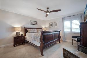 a bedroom with a bed and a ceiling fan at Take in the oceanfront corner views located on the no-drive beach! in New Smyrna Beach