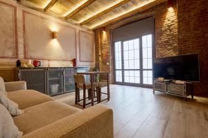a living room with a television and a table and chairs at Red Moon-Emme Loft in Milan
