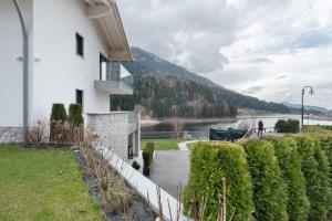 a house with a view of a river and a mountain at Relais Dolomiti in Bedollo