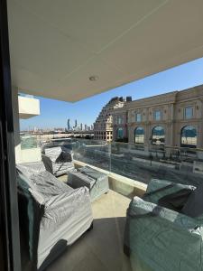 a view of a city from a window with mattresses at The Vendome view luxury apartment in Lusail