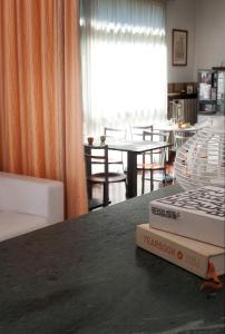 a room with a table with a book on top of it at Hotel Caselle in San Lazzaro di Savena