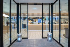 a display case in a room with glass doors at Prize by Radisson, Bern City in Bern
