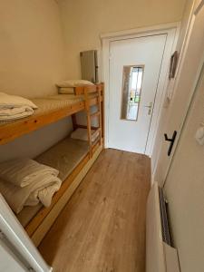 a small room with two bunk beds and a door at Studio chaleureux à Font-Romeu in Font-Romeu