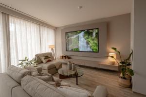 a living room with a couch and a tv at Athens Soho Lofts -Evaggelistrias 18 in Athens