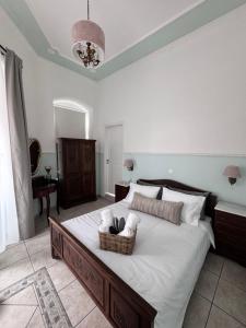 a bedroom with a large bed with a basket on it at Apiro Syros in Ermoupoli