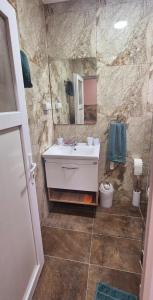 a bathroom with a sink and a mirror at Apartmani IMW in Zaječar +22 photos