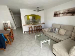 a living room with a couch and a table at Spacious, calm and bright Duplex Apartment in Private Residence ideal for families, beach and golf in Sitio de Calahonda