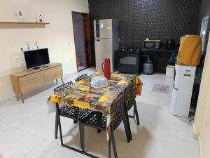 a kitchen with a table with a table cloth on it at Nova casa de praia na Caponga in Cascavel