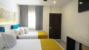 Postel nebo postele na pokoji v ubytování Hotel Loreto Palmar
