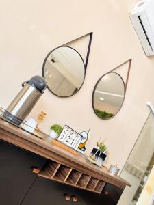a shelf with three mirrors on a wall at Hotel Leda Rafael in João Câmara +51 photos