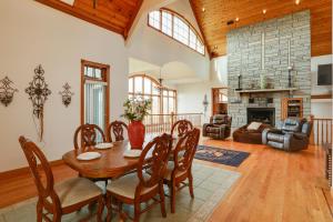 a dining room with a table and a fireplace at 366 Shared Acres, Lake Access: Ozark Getaway! in Fairfield Bay