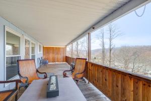 a porch with two chairs and a table on it at Lake Views and Private Dock Radford Retreat! in Radford