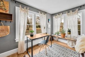 a home office with a desk and two windows at Asheville Urban Farmhouse Entire Home 4 mi to DT in Asheville