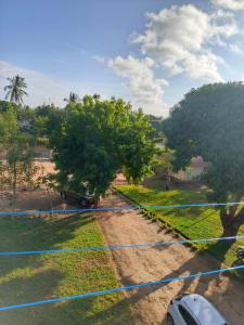 ウクンダにあるCatwalk Factory Apartmentの木の横の未舗装路に停車したトラック