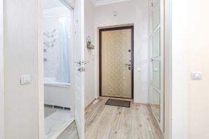 a hallway with a door and a wooden floor at Мангилик жилой комплекс in Astana