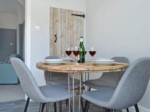 una mesa con copas de vino y botellas de vino. en The Beach House, en Saint Annes on the Sea