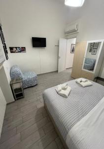 a bedroom with a bed with two towels on it at Florence Dalmazia Fast Check In on line in Florence