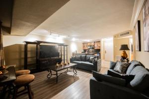 a living room with two couches and a tv at StripViewSuites at Jockey Club in Las Vegas