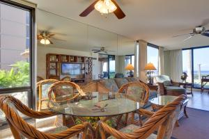 a living room with a glass table and chairs at Lahaina Condo with Patio, Ocean Views and Pool Access! in Kahana