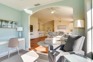 a living room with two couches and a kitchen at 3 Mi to Dtwn Mt Dora Golf Getaway! in Mount Dora