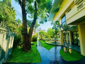 a walkway in the yard of a house with a tree at 5BR Villa with Private Pool Sukhumvit 10mins BTS in Bangkok