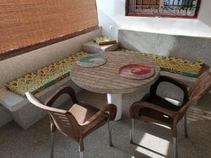 a table and two chairs in front of a couch at Sene Centro Résidence in Cap Skirring +10 photos