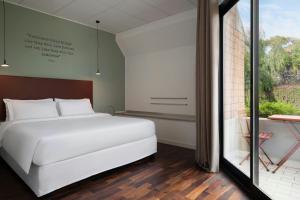 Un ou plusieurs lits dans un hébergement de l'établissement Four Points by Sheraton Catania Hotel