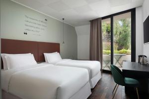 Un ou plusieurs lits dans un hébergement de l'établissement Four Points by Sheraton Catania Hotel