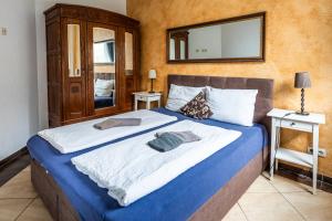 a bedroom with a large bed with a mirror on the wall at Villa Backstein OBO19 in Schwerin