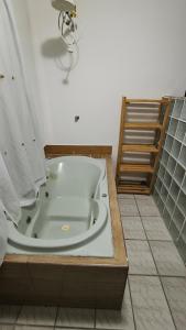 a bath tub in a bathroom with a staircase at Casa De Praia Baptista Resort Jacaraípe in Serra