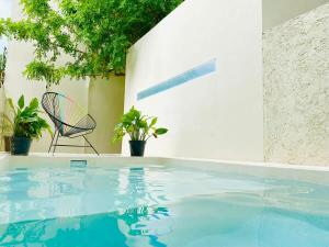 una sedia accanto alla piscina di Sweet Apartment Tulum town Great Pool a Tulum