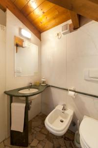 a bathroom with a sink and a toilet at Hotel Caselle in San Lazzaro di Savena
