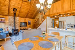 a kitchen and living room with a table in a room at Play Chalet MCA 489 - Meredith Lodging in Manzanita