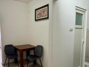 a small table and two chairs in a room at Walk to Everything! in Prizren