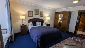 a hotel room with a bed and a chair at Foley's Townhouse Killarney in Killarney