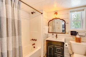 a bathroom with a sink and a toilet and a tub at Hike, Fish and Boat Waterfront Cabin in Ryegate! in East Ryegate +21 photos