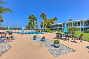 a resort with a pool and chairs and umbrellas at Condo on St Johns River with Boat Dock Access! in Welaka