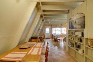 a kitchen and dining room with a table and chairs at Quiet Deer River Cabin with Dock and Lake View! in Deer River