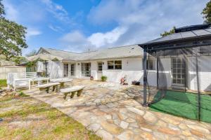a patio with a bench and a house at 2 Mi to Shore Modern Retreat in Fort Walton Beach in Fort Walton Beach