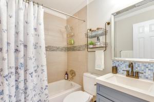 a bathroom with a sink and a toilet and a tub at 2 Mi to Shore Modern Retreat in Fort Walton Beach in Fort Walton Beach +16 photos
