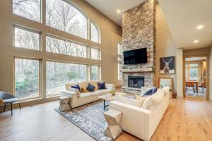 a large living room with a stone fireplace at Group Getaway! 8,000-Sq-Ft Gem, Arcade + Theater in Beech Mountain