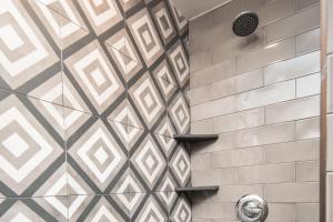 a shower with a tiled wall with a shower at Group Getaway! 8,000-Sq-Ft Gem, Arcade + Theater in Beech Mountain +37 photos